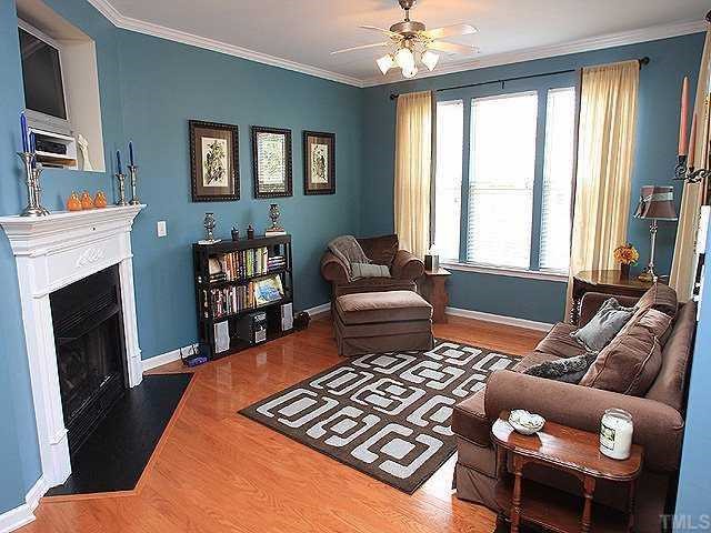 5315 Silver Moon Lane Raleigh, NC 27606 - Photo 2 of 12 Spacious family room boasts hardwood floors, crown molding, gas logs fireplace, TV nook and ceiling fan. Two-inch blinds throughout and window treatments convey!