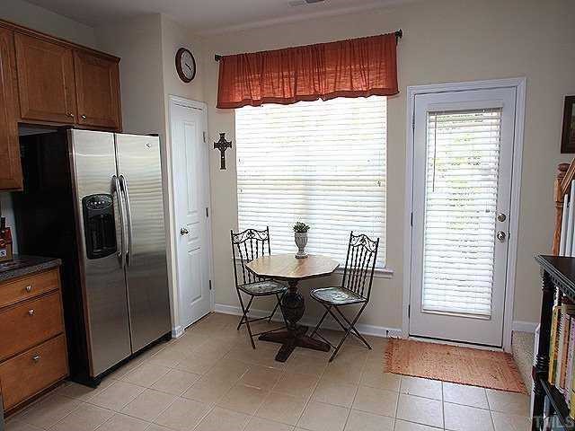 5315 Silver Moon Lane Raleigh, NC 27606 - Photo 4 of 12 Kitchen is large enough for eat-in space and has access to private patio. The refrigerator, washer/dryer and window treatments convey making this home move-in ready!