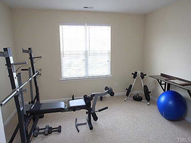 5315 Silver Moon Lane Raleigh, NC 27606 - Photo 7 of 12 Front bedroom features berber carpet, large walk-in closet and a full bath.
