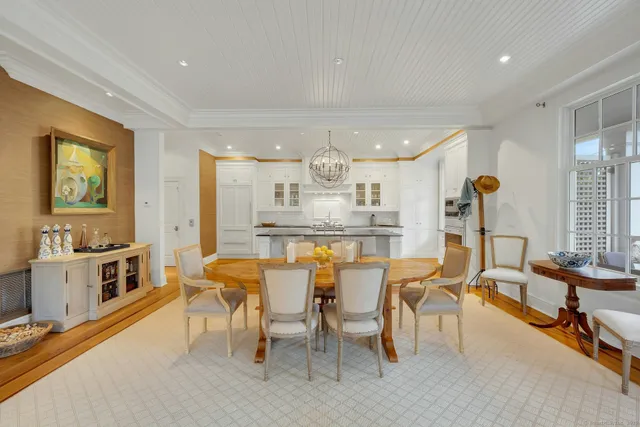 a large kitchen with stainless steel appliances granite countertop a stove and a wooden floors