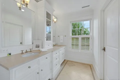 a bathroom with sink bathtub and window