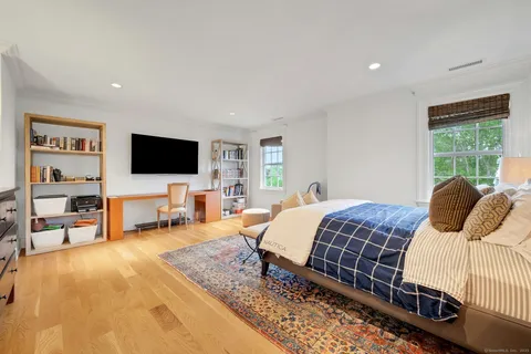 a bedroom with a bed and a flat screen tv