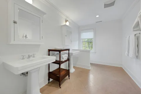 a bathroom with a sink a light fixture and a vanity