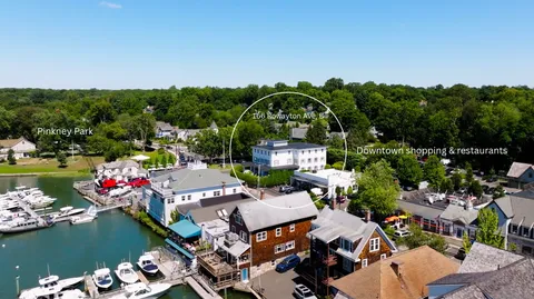 an aerial view of a house with a garden and lake view