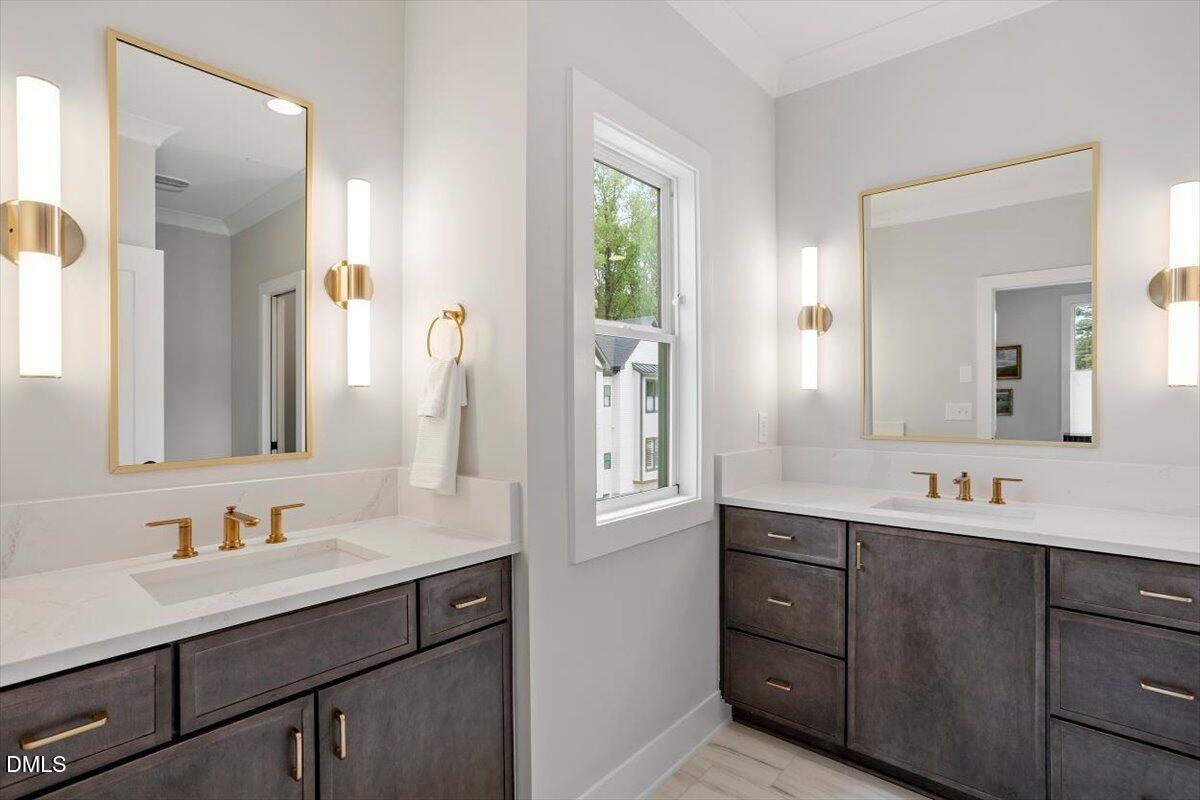 811 Maple Berry Lane, Unit 101 Raleigh, NC 27607 - Photo 25 of 45 a bathroom with a sink double vanity and a mirror