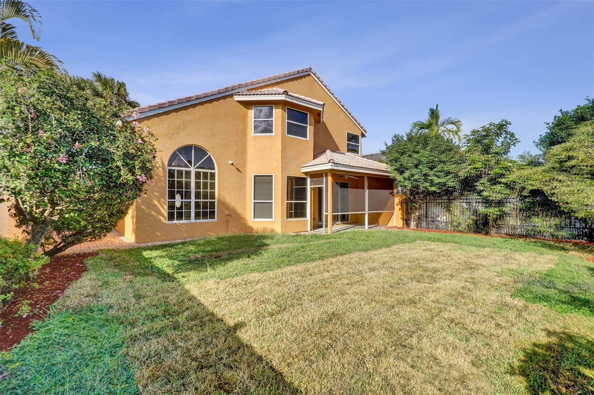 10902 Tamoron Lane Boca Raton, FL 33498 - Photo 62 of 66 a front view of a house with a garden