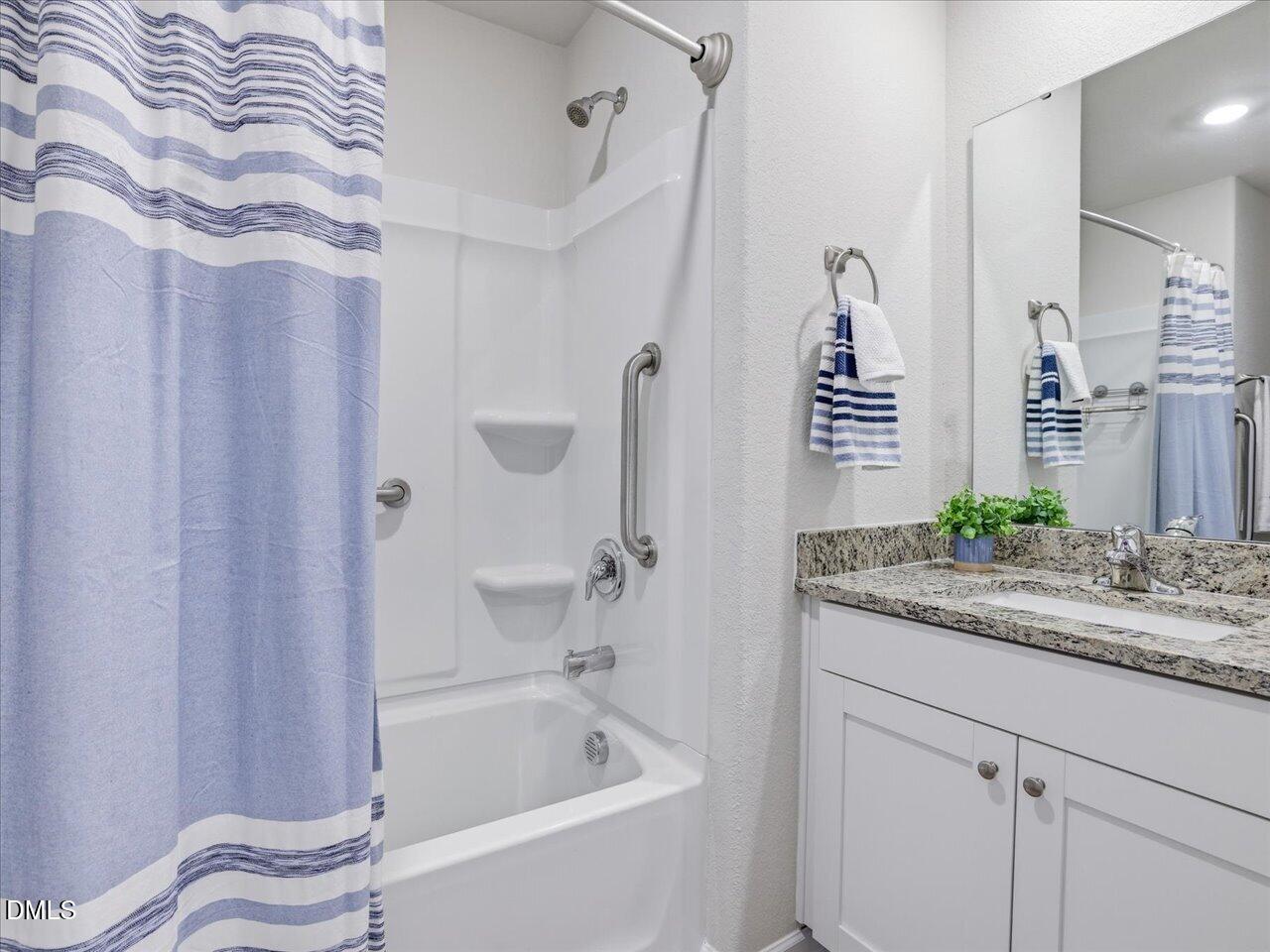 90 Barnsley Road Angier, NC 27501 - Photo 27 of 40 a bathroom with a granite countertop sink and a bathtub