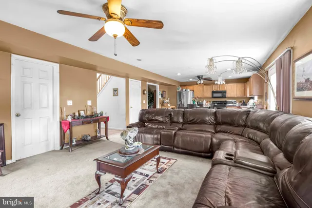 a living room with furniture and flowers