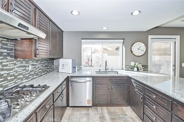 a view of a dining room with furniture a potted plant and a fireplace
