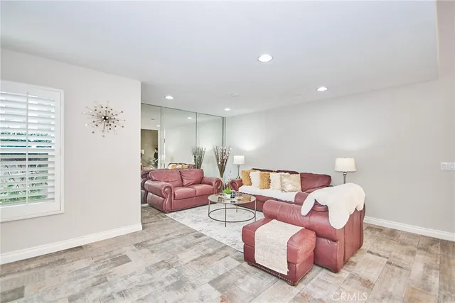 a view of a livingroom with furniture and a window