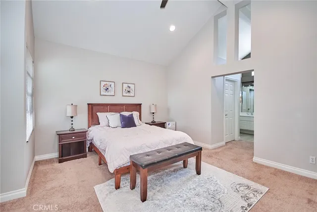 a view of a hallway with two windows and a livingroom view
