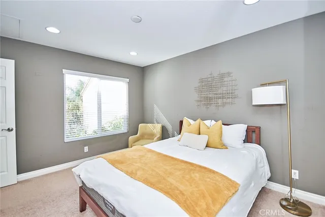 a bathroom with a granite countertop toilet sink and a mirror