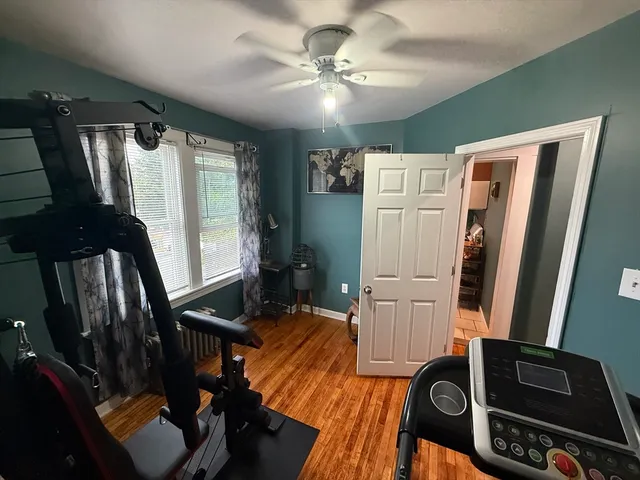 a view of a hallway with furniture and a window