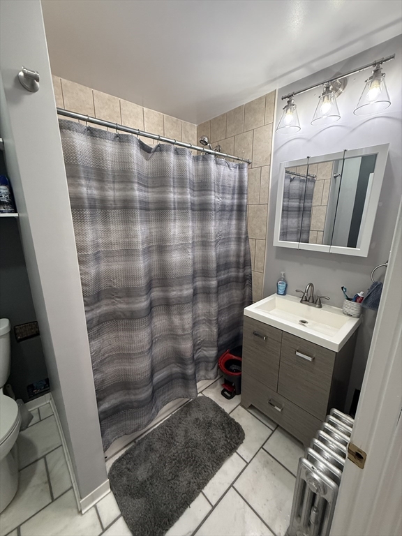 19 Oliver Street Worcester, MA 01603 - Photo 15 of 26 a bathroom with a sink and mirror