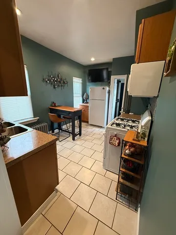 a living room with a couch and a stove top oven