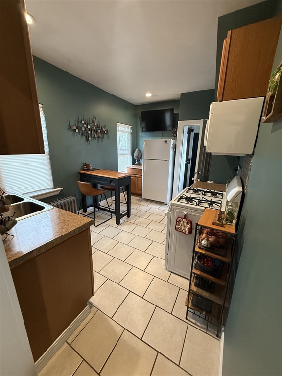 19 Oliver Street Worcester, MA 01603 - Photo 19 of 26 a living room with a couch and a stove top oven