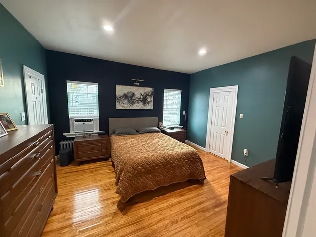 a bedroom with a large bed and a dresser