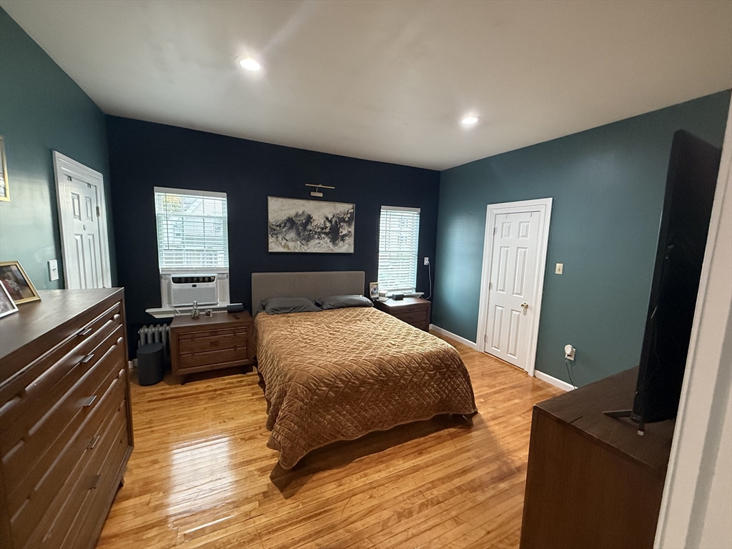 19 Oliver Street Worcester, MA 01603 - Photo 8 of 26 a bedroom with a large bed and a dresser
