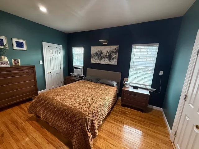 a bed sitting in a bedroom next to a window