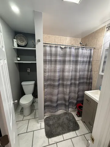 a bathroom with a toilet and a shower