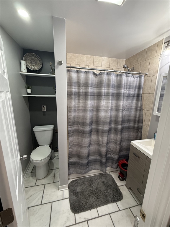 19 Oliver Street Worcester, MA 01603 - Photo 10 of 26 a bathroom with a toilet and a shower