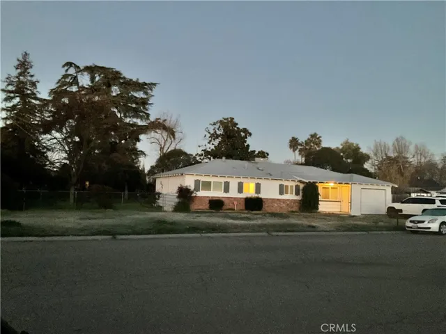 a front view of a house with a garden
