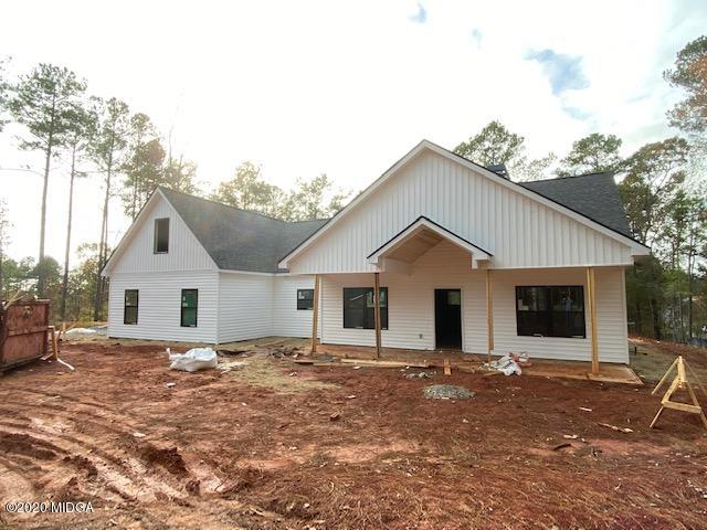 55 Jenkins Road Forsyth, GA 31029 - Photo 1 of 1 a view of a house with a yard covered in snow