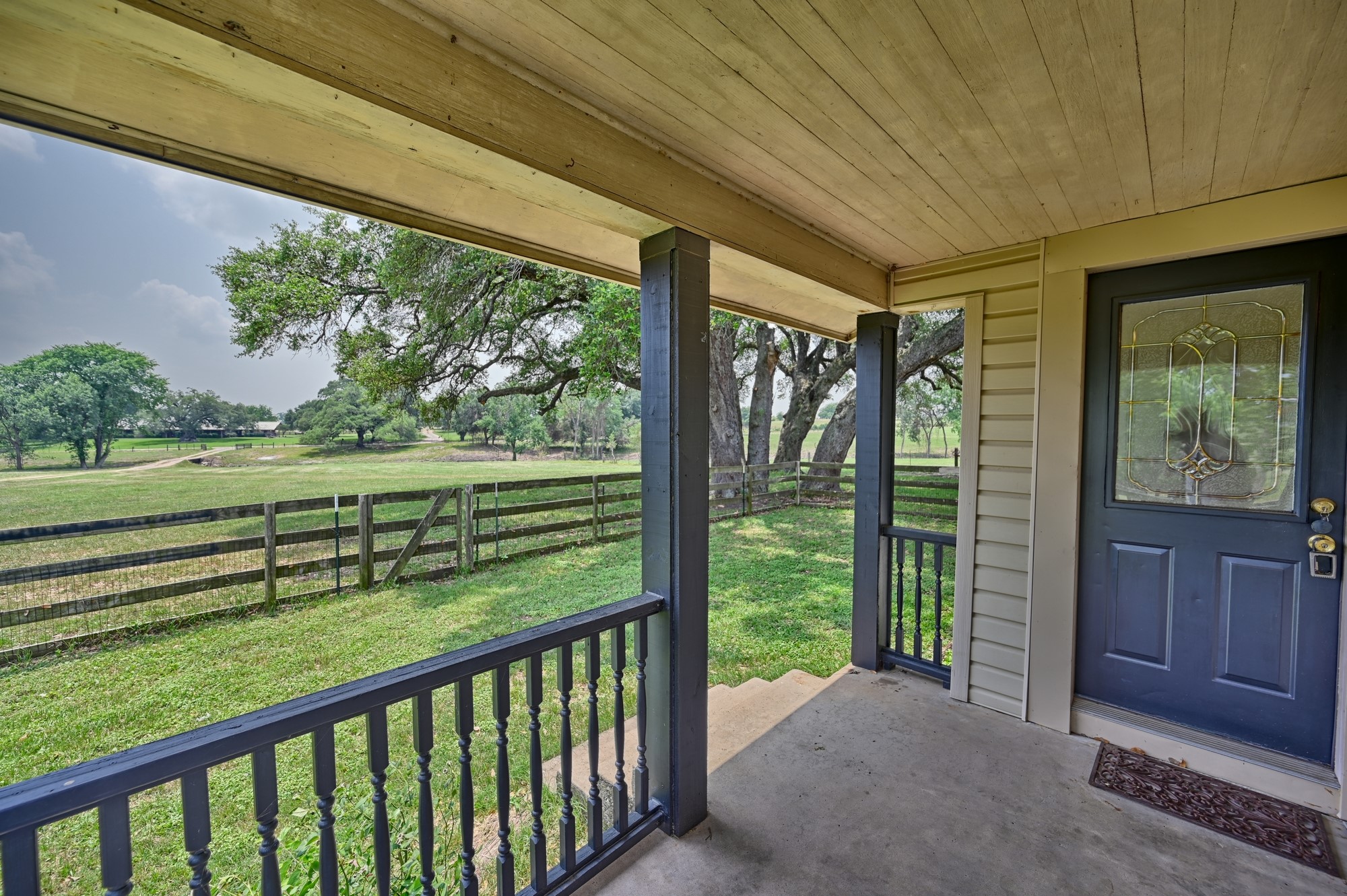 7009 Sandy Hill Road Brenham, TX 77833 - Photo 17 of 41 a view of a porch and garden