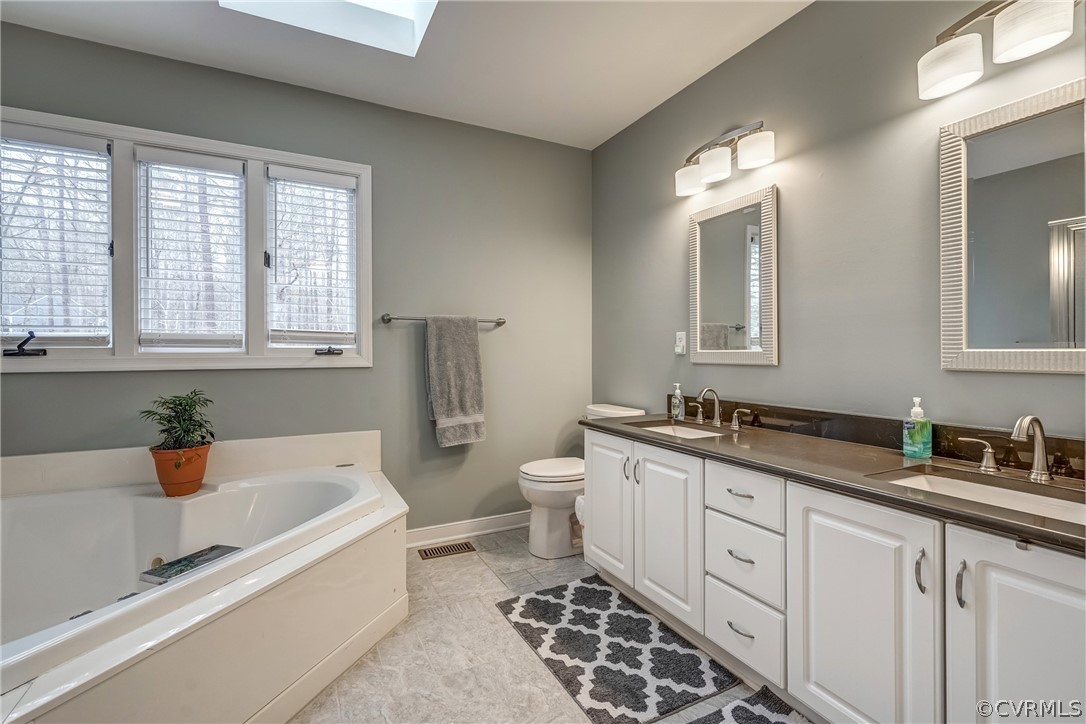 5913 Rosebay Forest Road Midlothian, VA 23112 - Photo 16 of 28 Primary Bath with Tile Floors, Skylight, Double Va