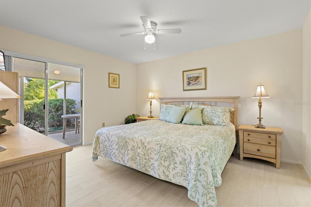 608 Pinebrook Crescent, Unit 8 Venice, FL 34285 - Photo 20 of 75 a bedroom with a bed and a large window