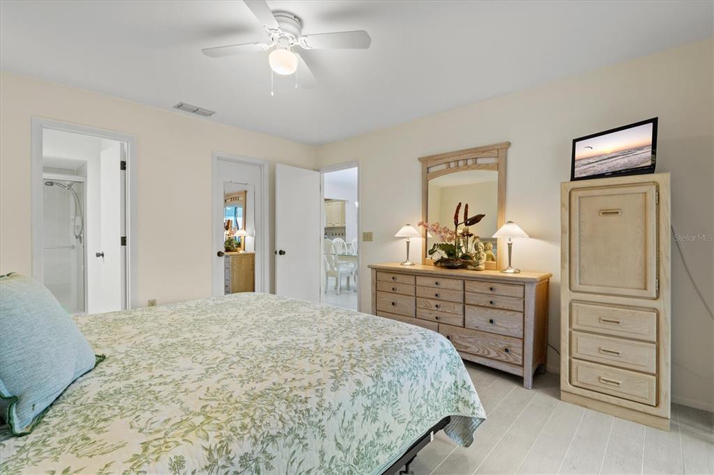 608 Pinebrook Crescent, Unit 8 Venice, FL 34285 - Photo 21 of 75 a bedroom with a bed and a dresser