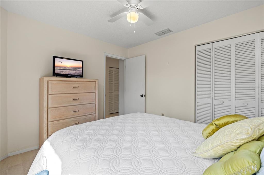 608 Pinebrook Crescent, Unit 8 Venice, FL 34285 - Photo 24 of 75 a bedroom with a bed and a night stand