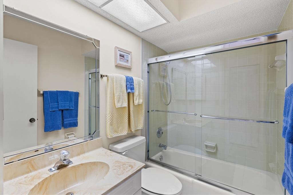 608 Pinebrook Crescent, Unit 8 Venice, FL 34285 - Photo 26 of 75 a bathroom with a sink toilet and shower