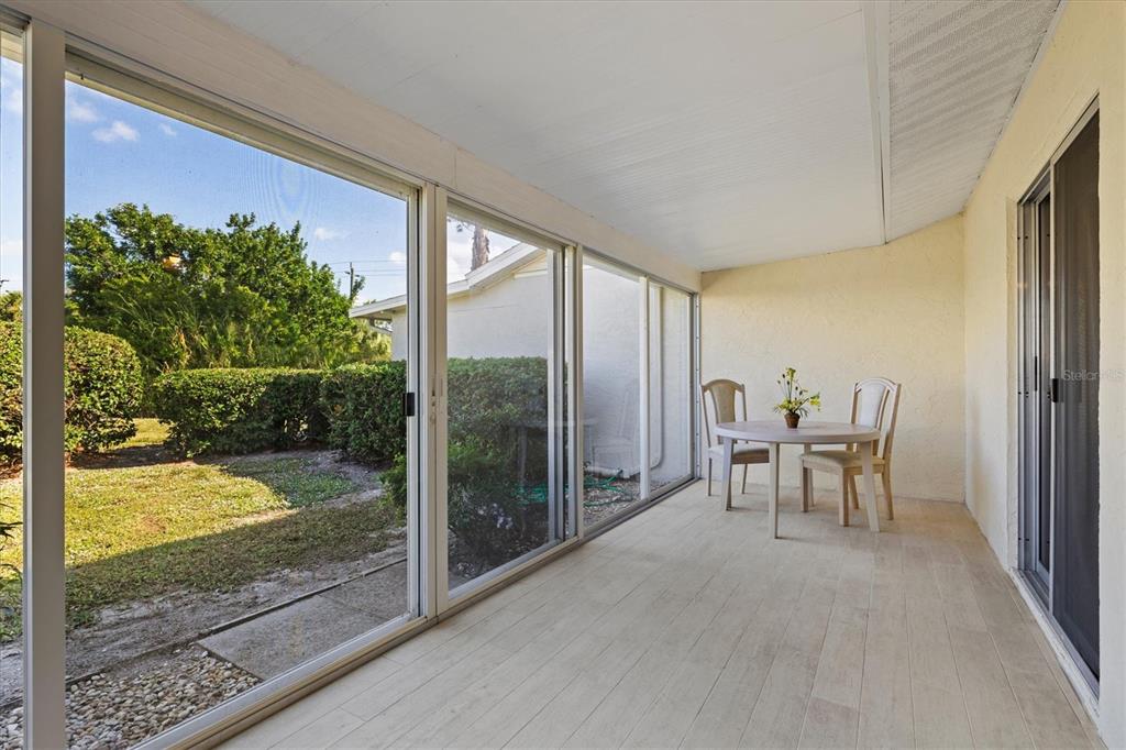 608 Pinebrook Crescent, Unit 8 Venice, FL 34285 - Photo 29 of 75 a view of a porch with chairs and backyard
