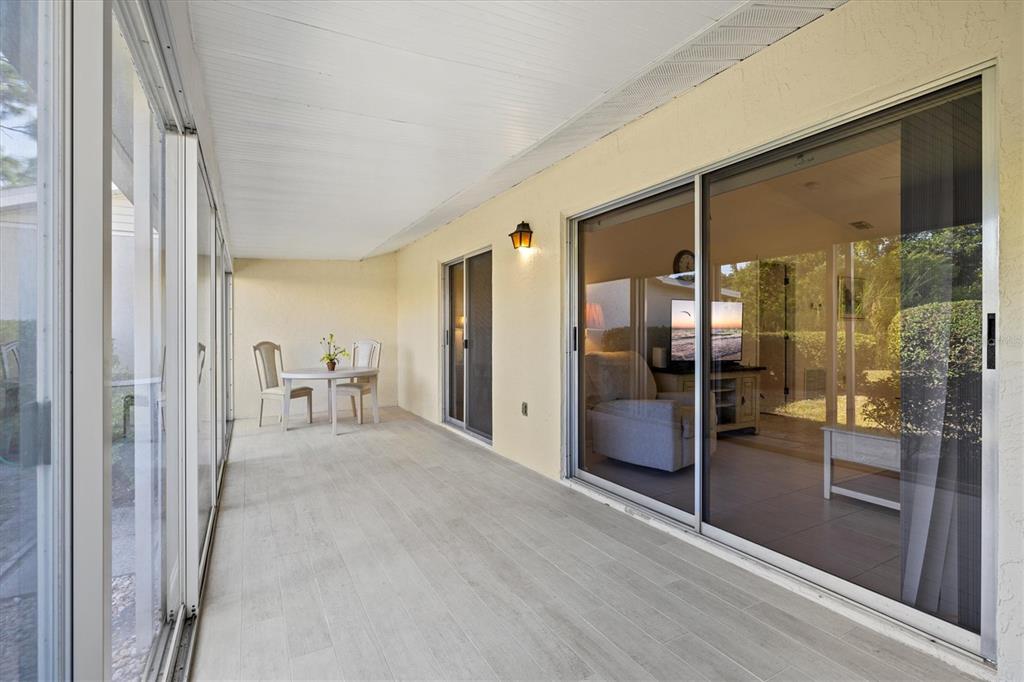608 Pinebrook Crescent, Unit 8 Venice, FL 34285 - Photo 30 of 75 a view of a bathroom with a glass shower door and mirror