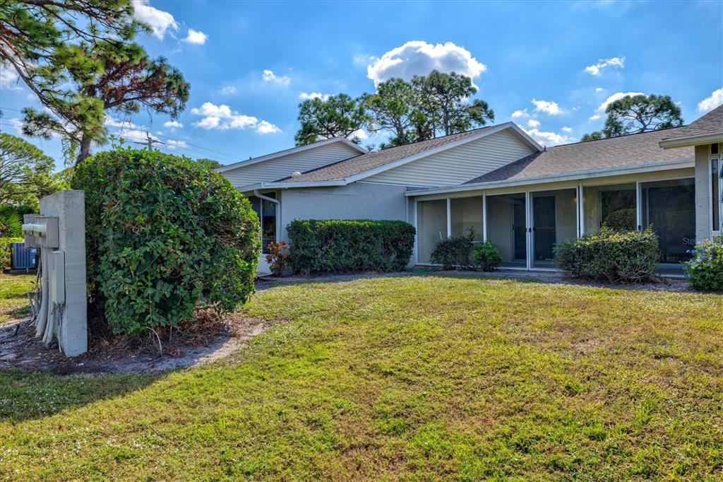 608 Pinebrook Crescent, Unit 8 Venice, FL 34285 - Photo 31 of 75 a view of a house with brick walls and potted plants