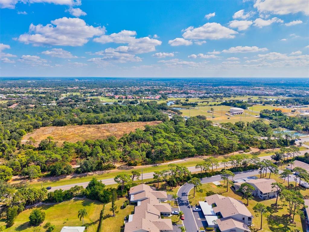 608 Pinebrook Crescent, Unit 8 Venice, FL 34285 - Photo 47 of 75 an aerial view of residential houses with outdoor space