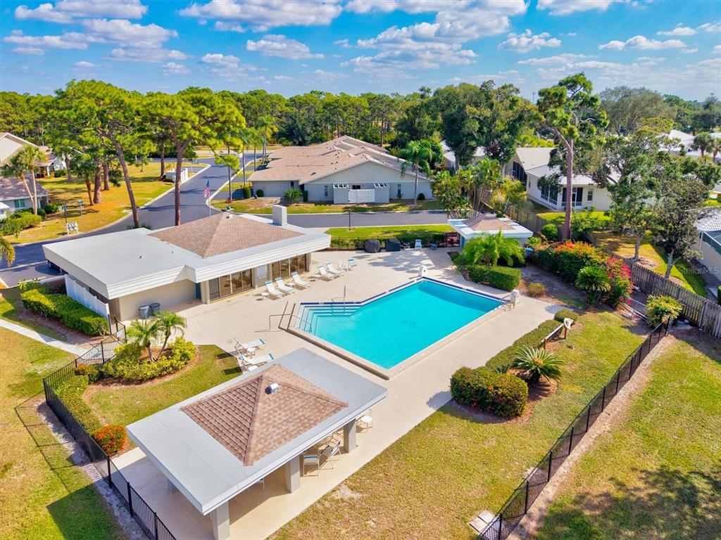 608 Pinebrook Crescent, Unit 8 Venice, FL 34285 - Photo 50 of 75 an aerial view of a house with swimming pool and a yard