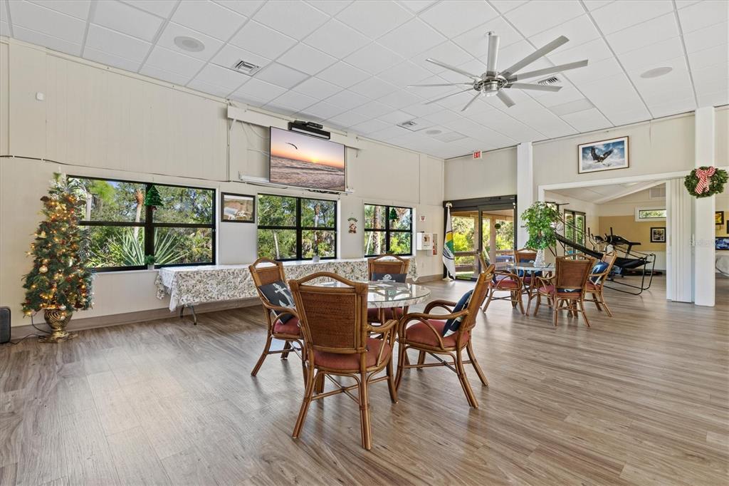 608 Pinebrook Crescent, Unit 8 Venice, FL 34285 - Photo 56 of 75 a view of a dining room with furniture window and wooden floor