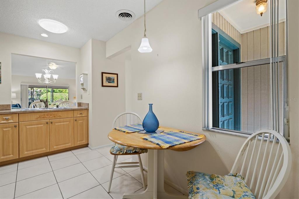 608 Pinebrook Crescent, Unit 8 Venice, FL 34285 - Photo 8 of 75 a view of a dining room with furniture