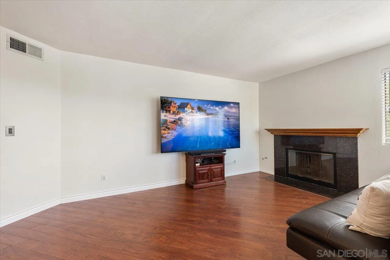 3003 Blue Oak Court Spring Valley, CA 91978 - Photo 13 of 39 a view of a livingroom with furniture a fireplace and wooden floor