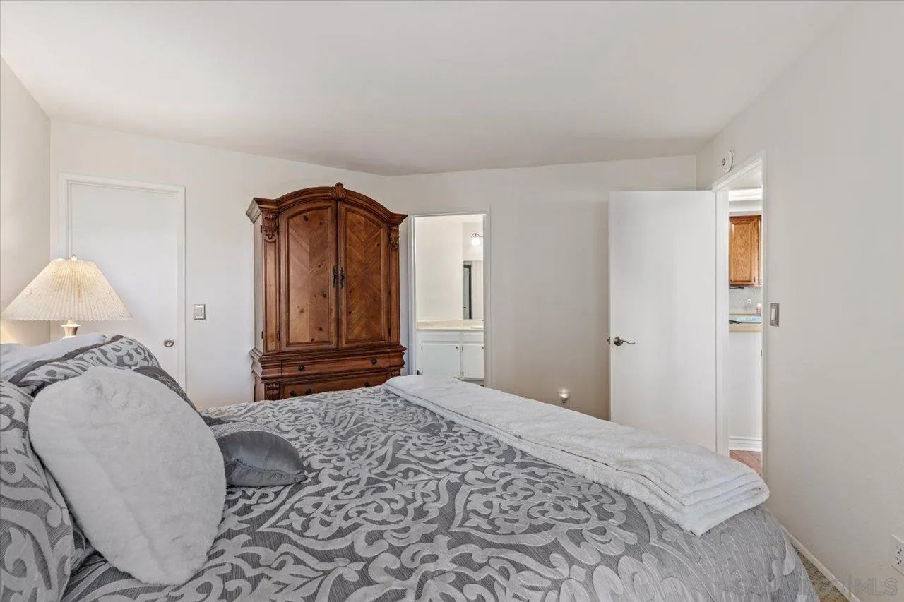 3003 Blue Oak Court Spring Valley, CA 91978 - Photo 22 of 39 a bedroom with a bed and a mirror