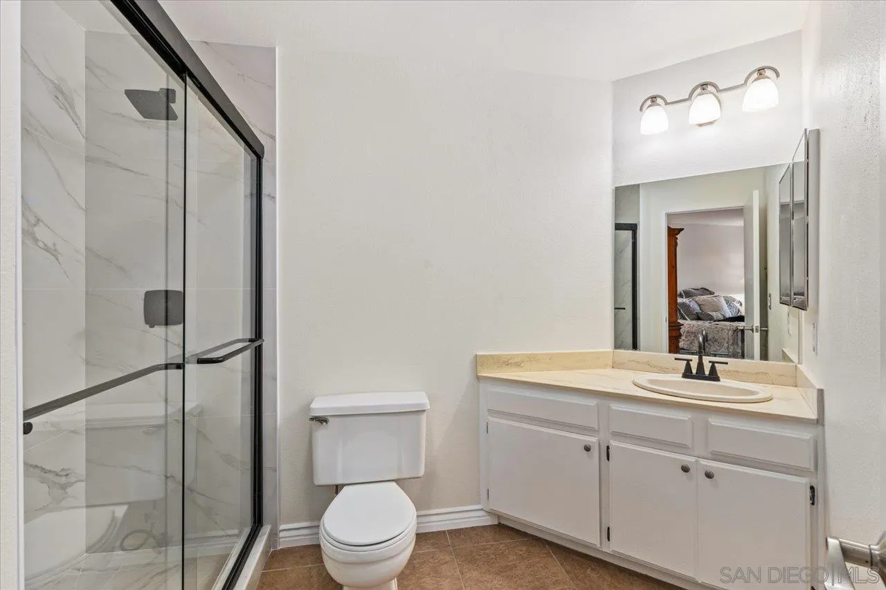 3003 Blue Oak Court Spring Valley, CA 91978 - Photo 23 of 39 a bathroom with a toilet a sink and mirror