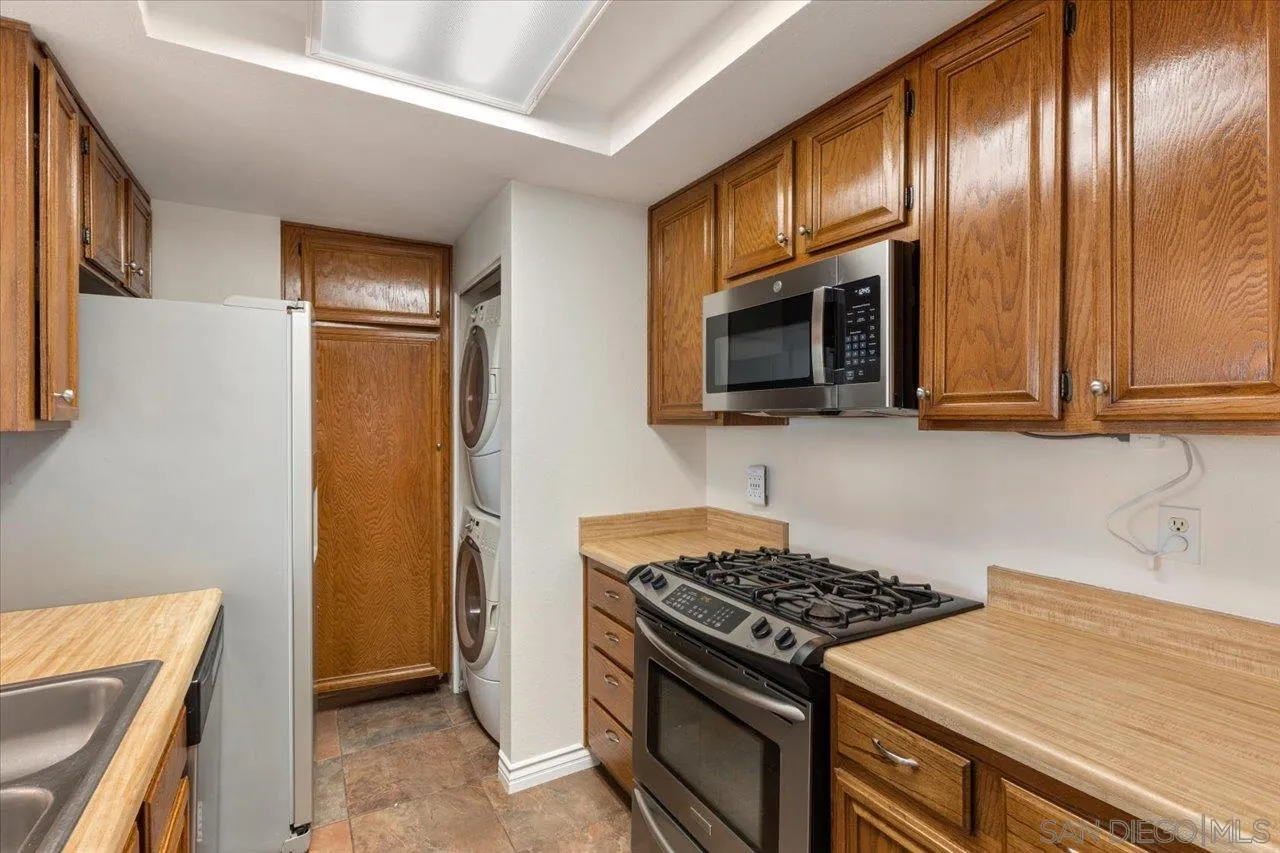 3003 Blue Oak Court Spring Valley, CA 91978 - Photo 8 of 39 a kitchen with wooden cabinets and a stove top oven
