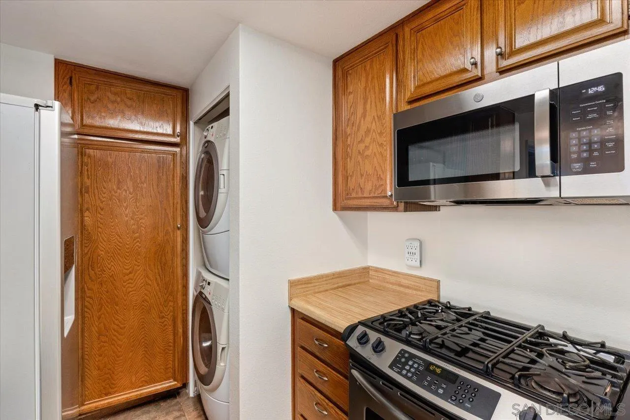 3003 Blue Oak Court Spring Valley, CA 91978 - Photo 9 of 39 a kitchen with stainless steel appliances granite countertop a stove and a microwave