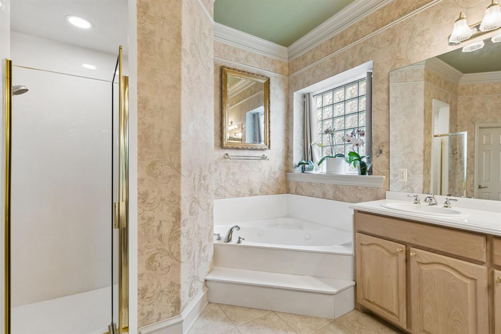 8517 Navigation Drive Rowlett, TX 75088 - Photo 24 of 39 a bathroom with a tub sink and mirror