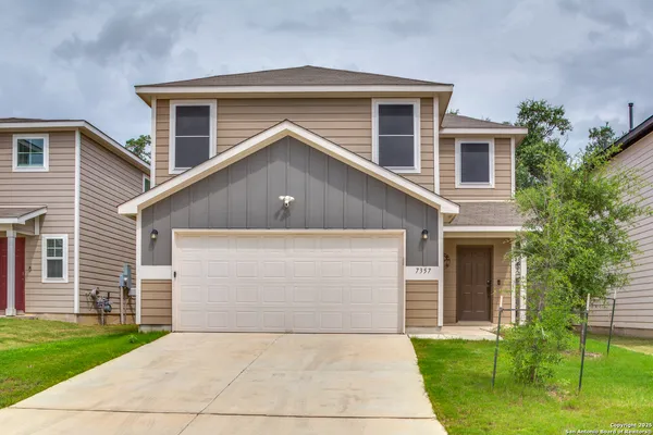 a front view of house with yard and green space