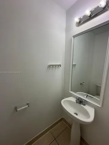 a bathroom with a sink and mirror