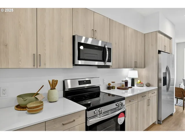 a kitchen with stainless steel appliances granite countertop a sink stove and microwave