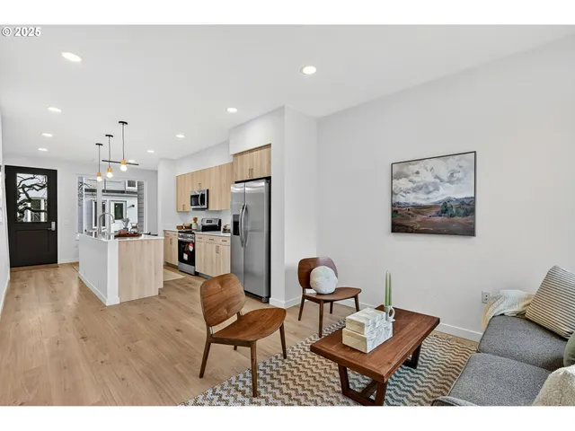 a living room with furniture and kitchen view